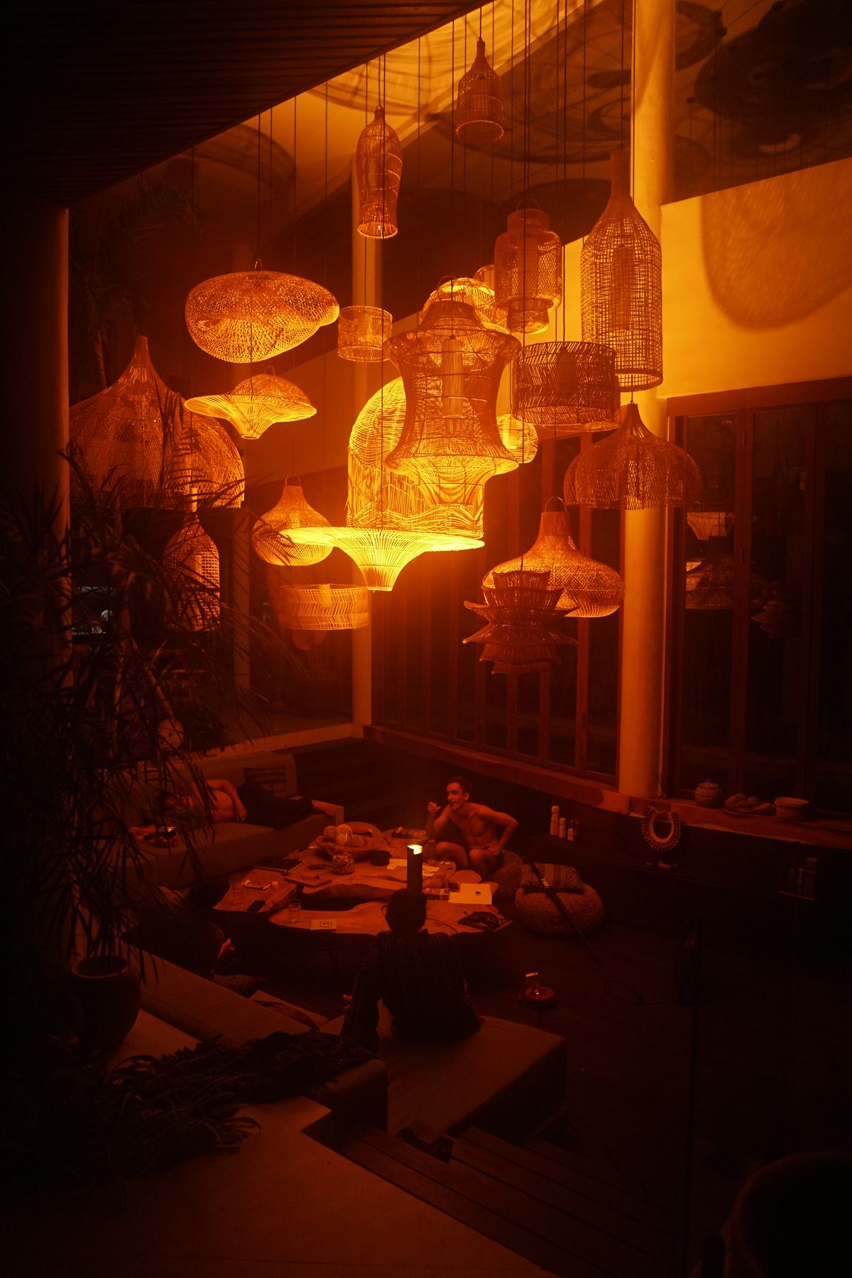 People around a table lit by AVA Light, evening atmosphere